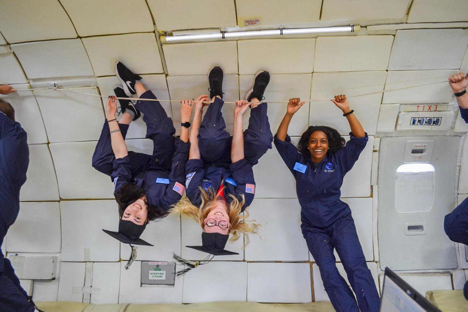 Students on board NASA?s zero gravity aircraft take a break from conducting research to celebrate...